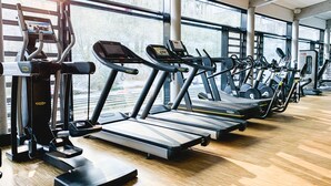 A gym with treadmills, ellipticals, and weight machines.