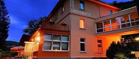 A two-story building with a sign reading "HAUS LINDENBACH".