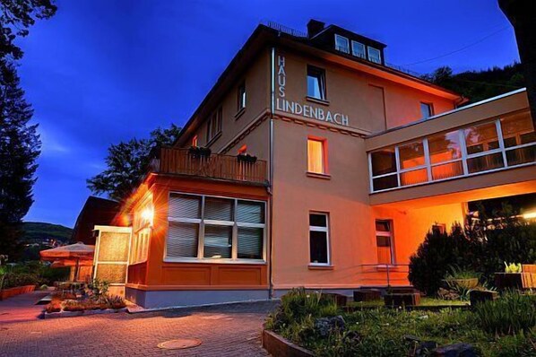 A two-story building with a sign reading "HAUS LINDENBACH".