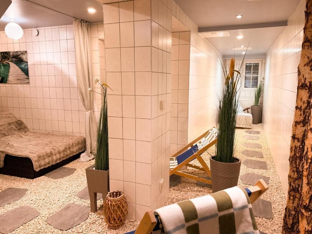 A spa area with a massage chair, a small table, and a potted plant.