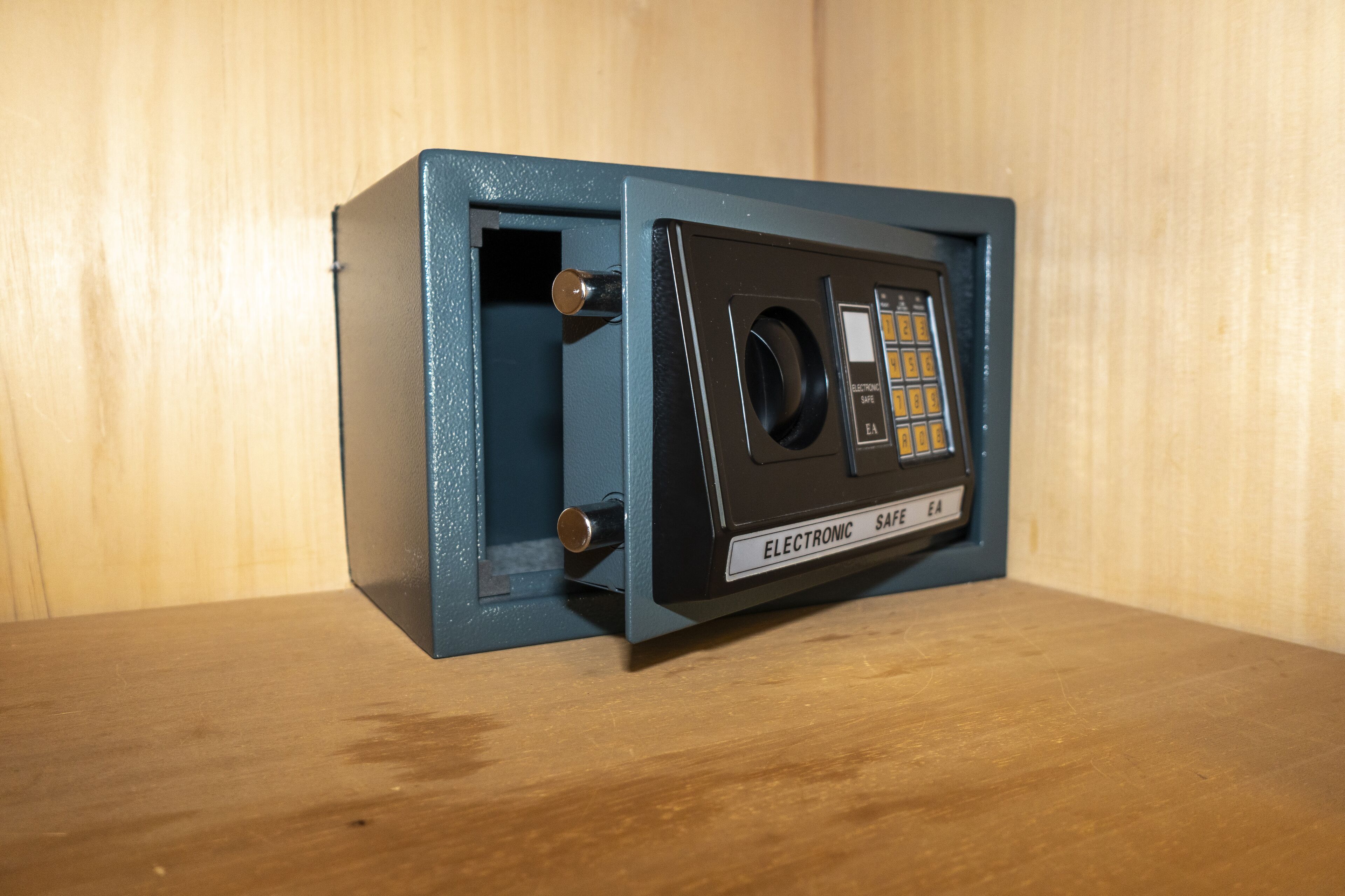 A blue safe with a keypad and a dial lock.