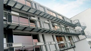 A multi-story building with external fire escapes and balconies. - Boardinghouse Bielefeld (Bielefeld)