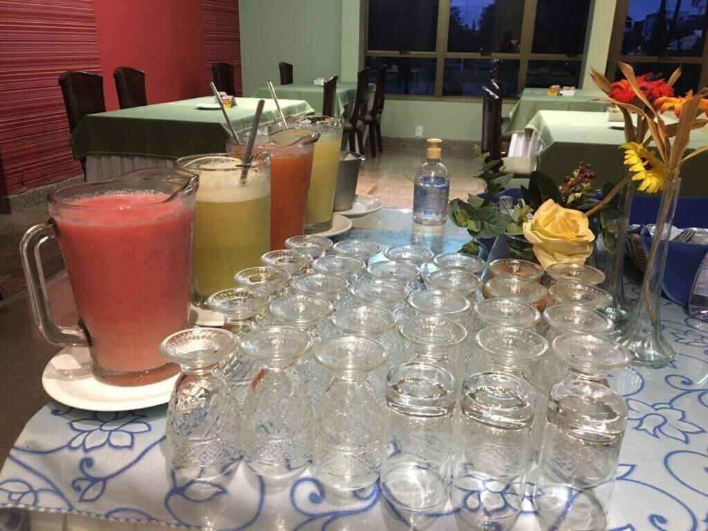 Mesa dispuesta con varias bebidas y vasos vacíos, indicando un servicio de bar.
