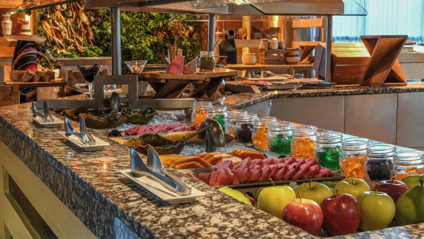 A buffet with various food items and condiments. - Generations Riviera Maya Oceanfront Family Resort, All & More Inclusive (Playa del Carmen)