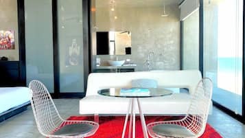 Honeymoon Studio Suite, Sea View | Living area | 40-inch flat-screen TV with satellite channels, TV, iPod dock