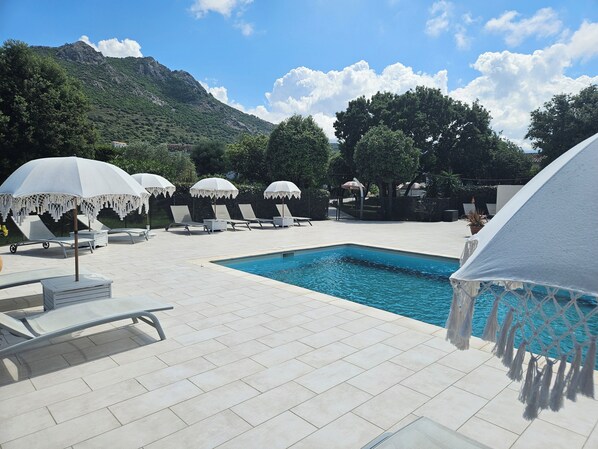 Seasonal outdoor pool, open 9:00 AM to 7:00 PM, pool umbrellas