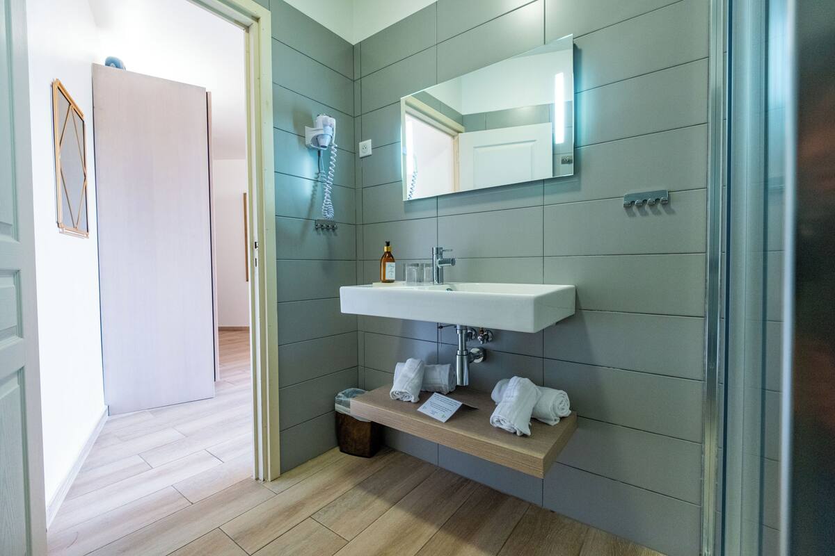 superior room | bathroom | shower, rainfall showerhead, hair dryer, towels