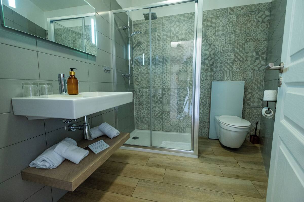 superior room | bathroom | shower, rainfall showerhead, hair dryer, towels
