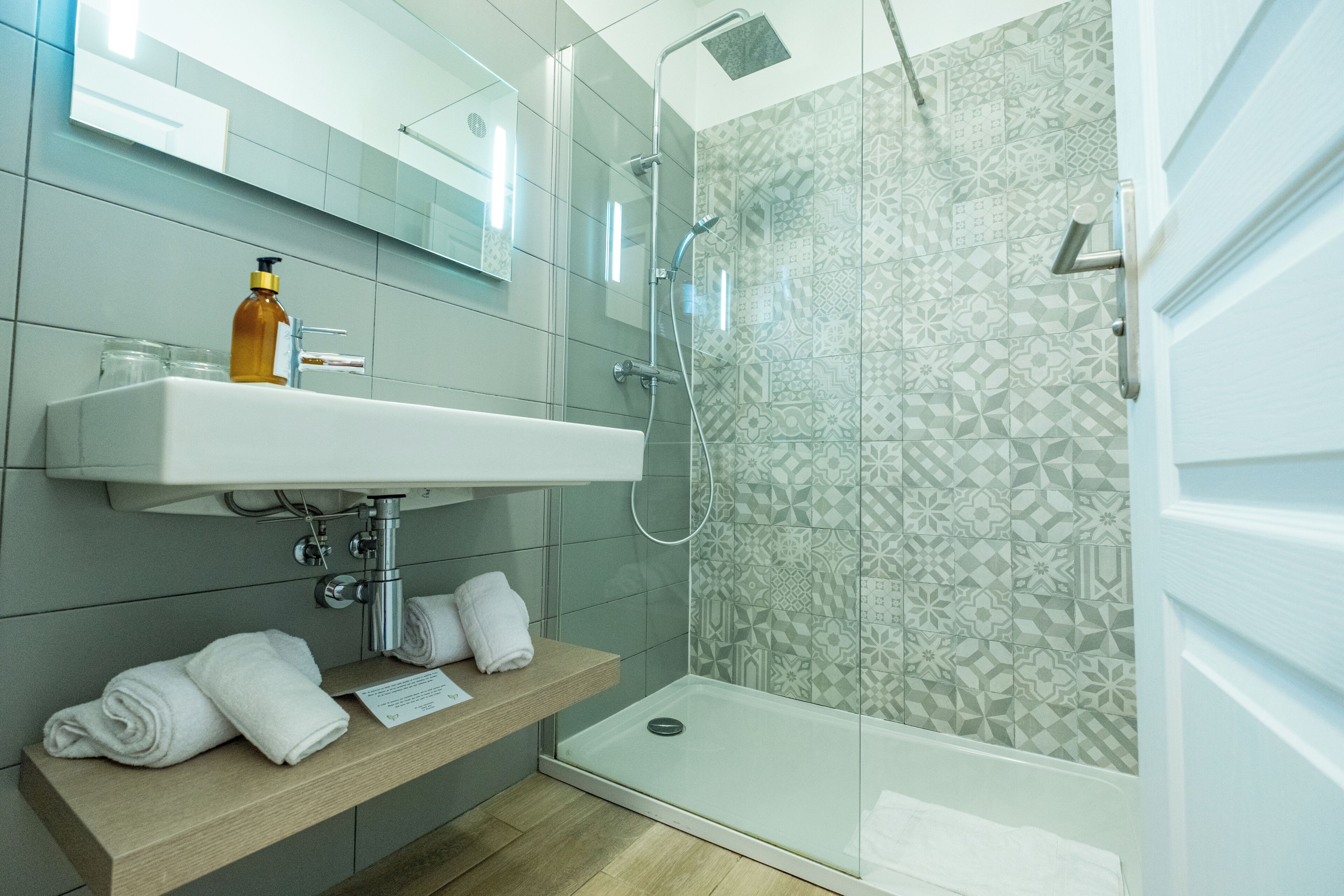 standard room | bathroom | shower, rainfall showerhead, hair dryer, towels