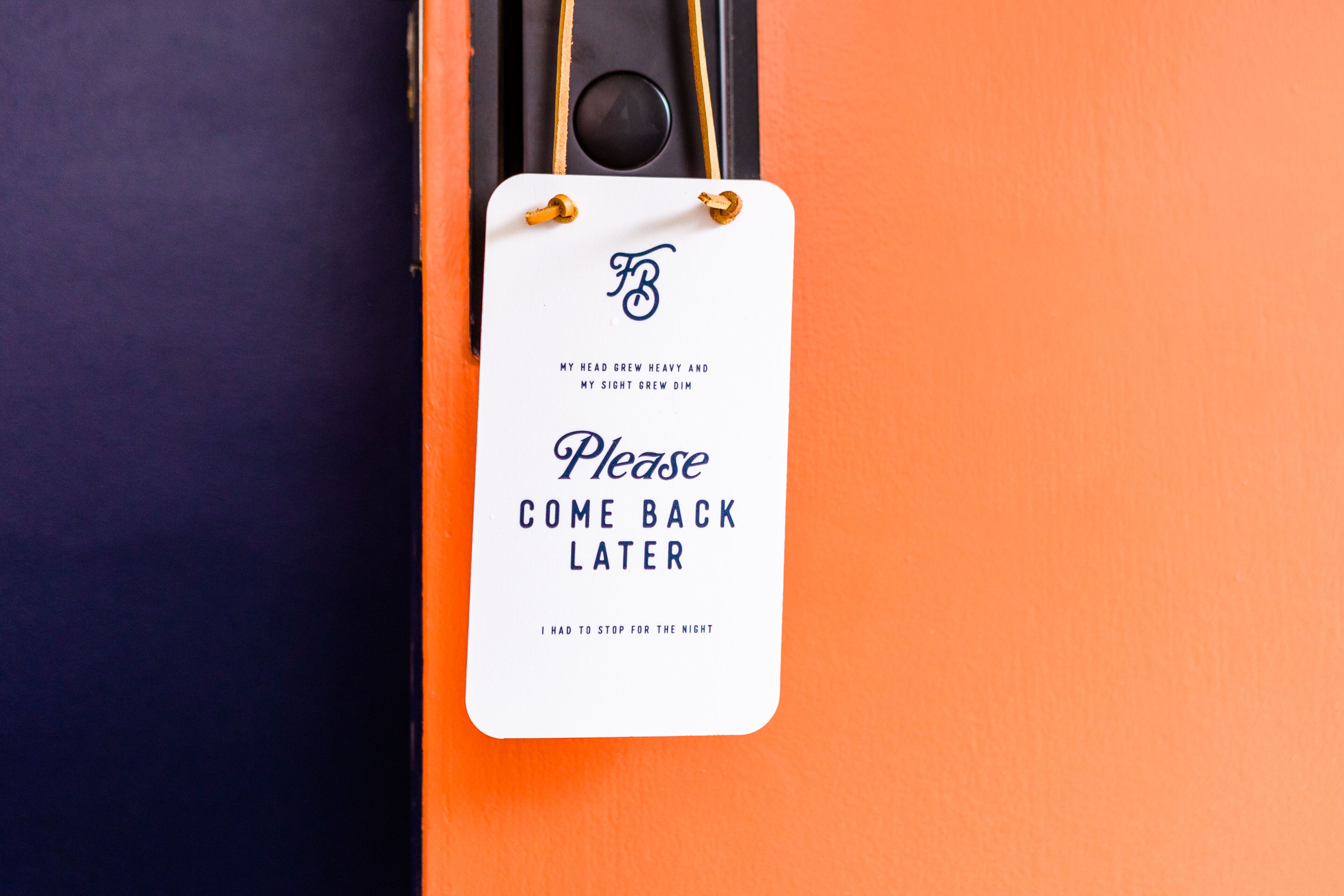 A white tag with text on a black and orange background.