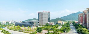 Experience the vibrant cityscape from the comfort of Ramada Plaza, surrounded by lush green spaces and modern architecture.