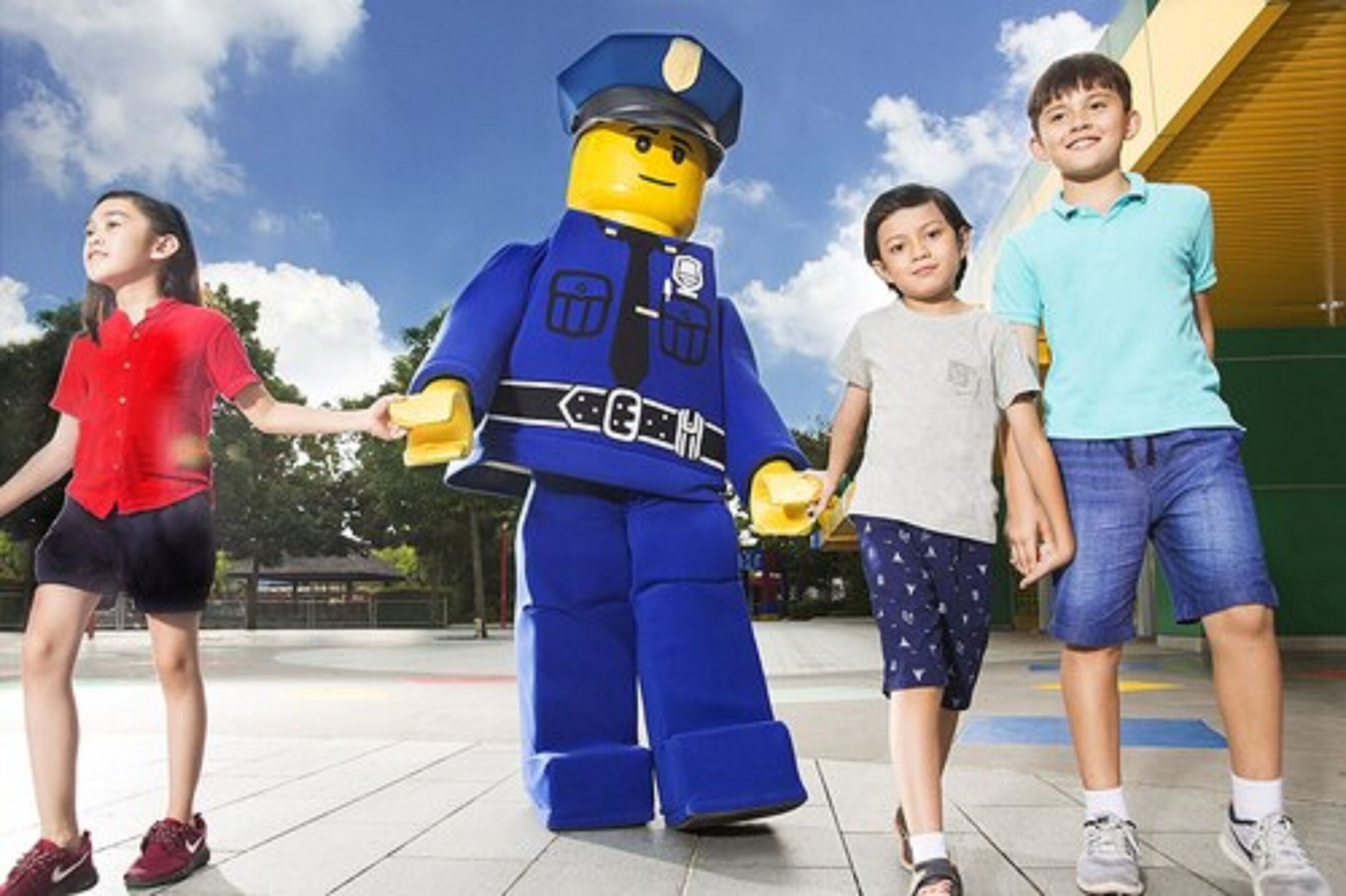 A group of children with a LEGO police officer.