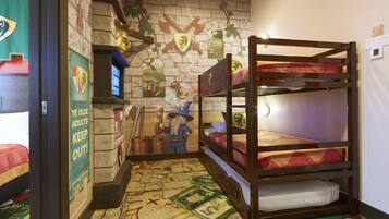 A bunk bed room with a medieval-themed wall, a small desk, and a poster on the wall.