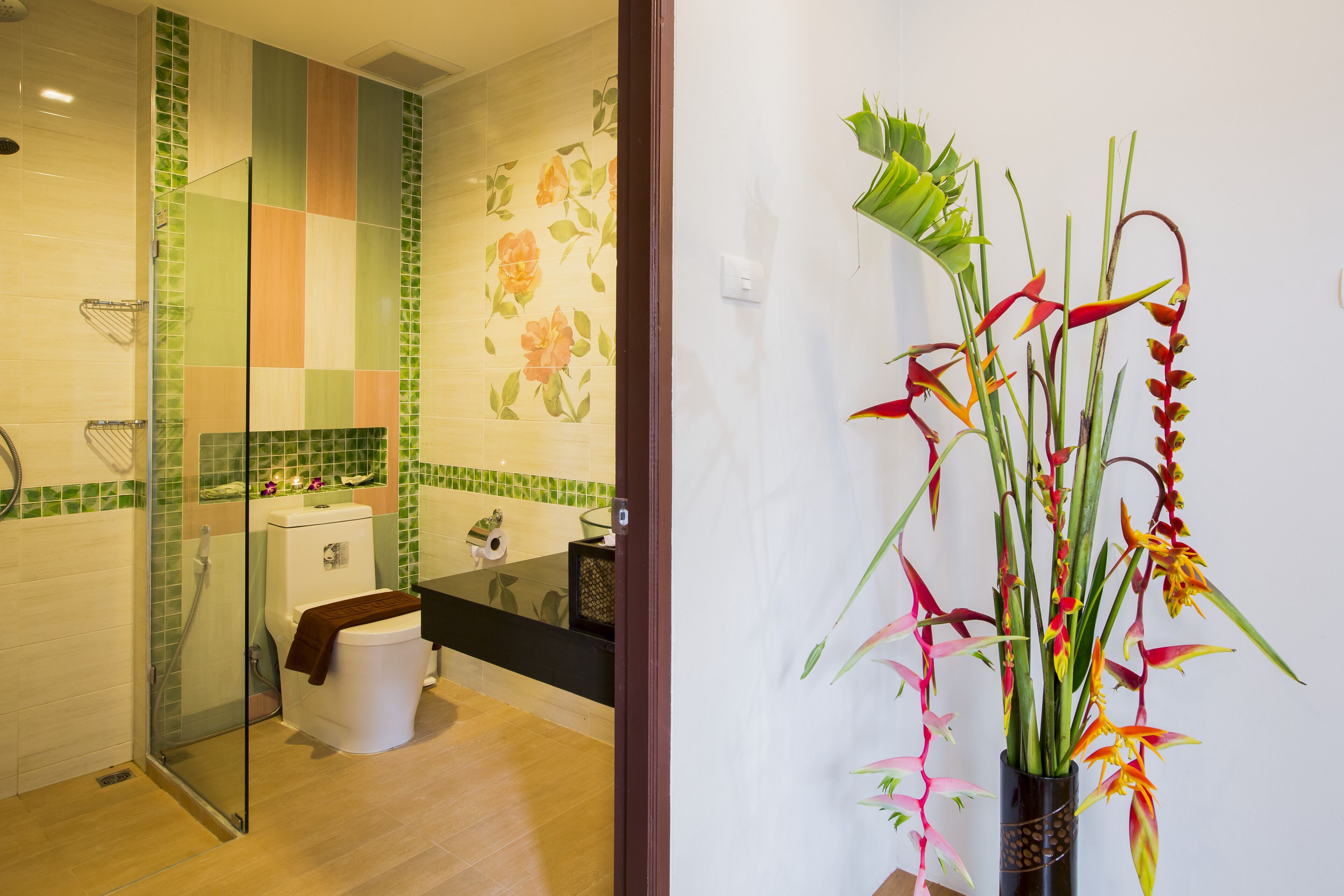A bathroom with a glass shower enclosure, a toilet, a sink, and a bathtub.