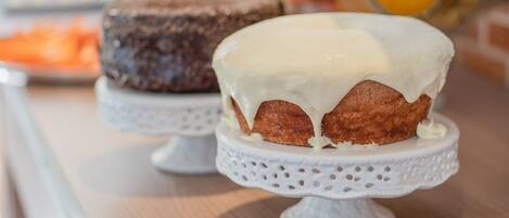 Cakes sit atop elegant cake stands with intricate lace detailing.