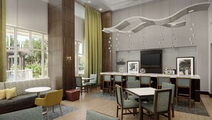 A modern hotel lobby with a seating area, a bar, and a television.