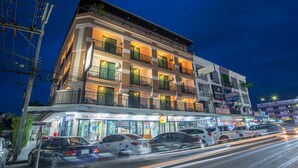 A multi-story hotel with balconies, a ground-level shop, and parked cars. - Lada Krabi Residence (Krabi)