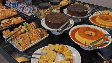 A buffet with various desserts and bread.