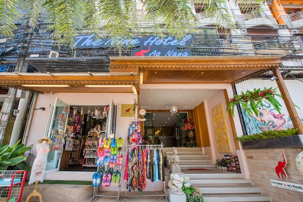 A hotel entrance with a sign reading "The Nine Hotel Ao Nang".