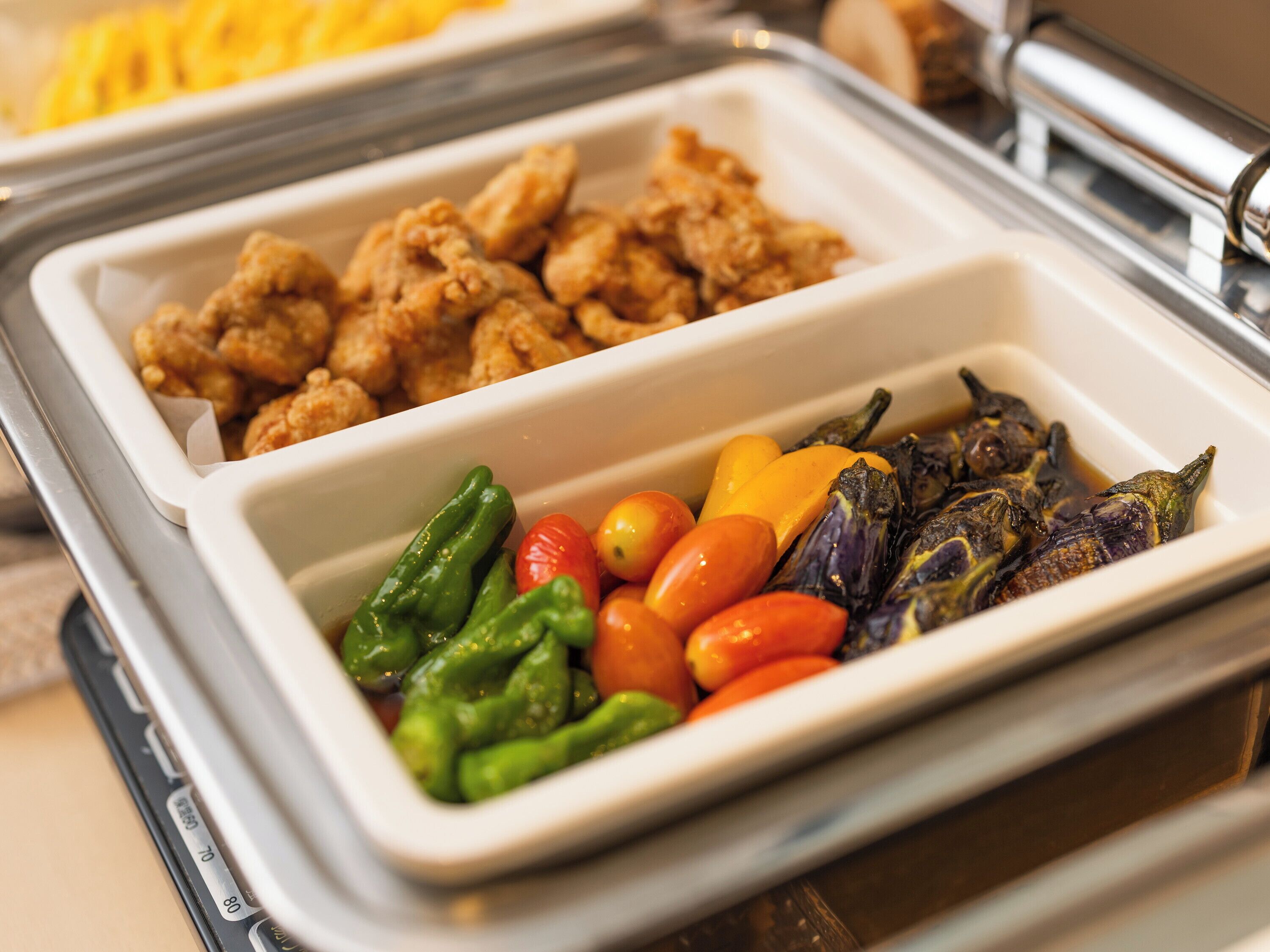 A buffet with fried chicken and a variety of vegetables.