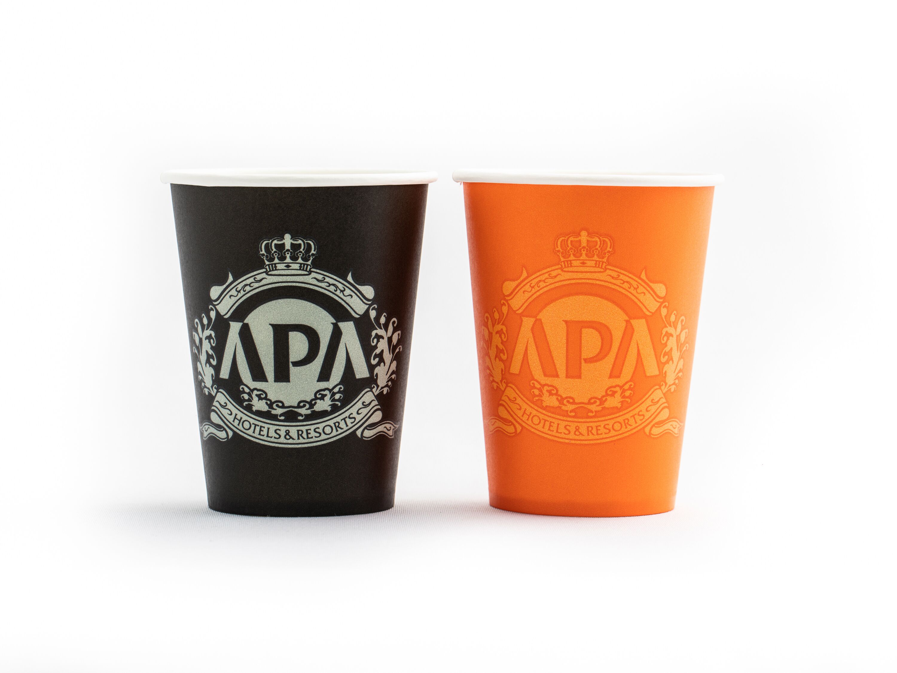 Two cups with the APA Hotels & Resorts logo, one black and one orange.