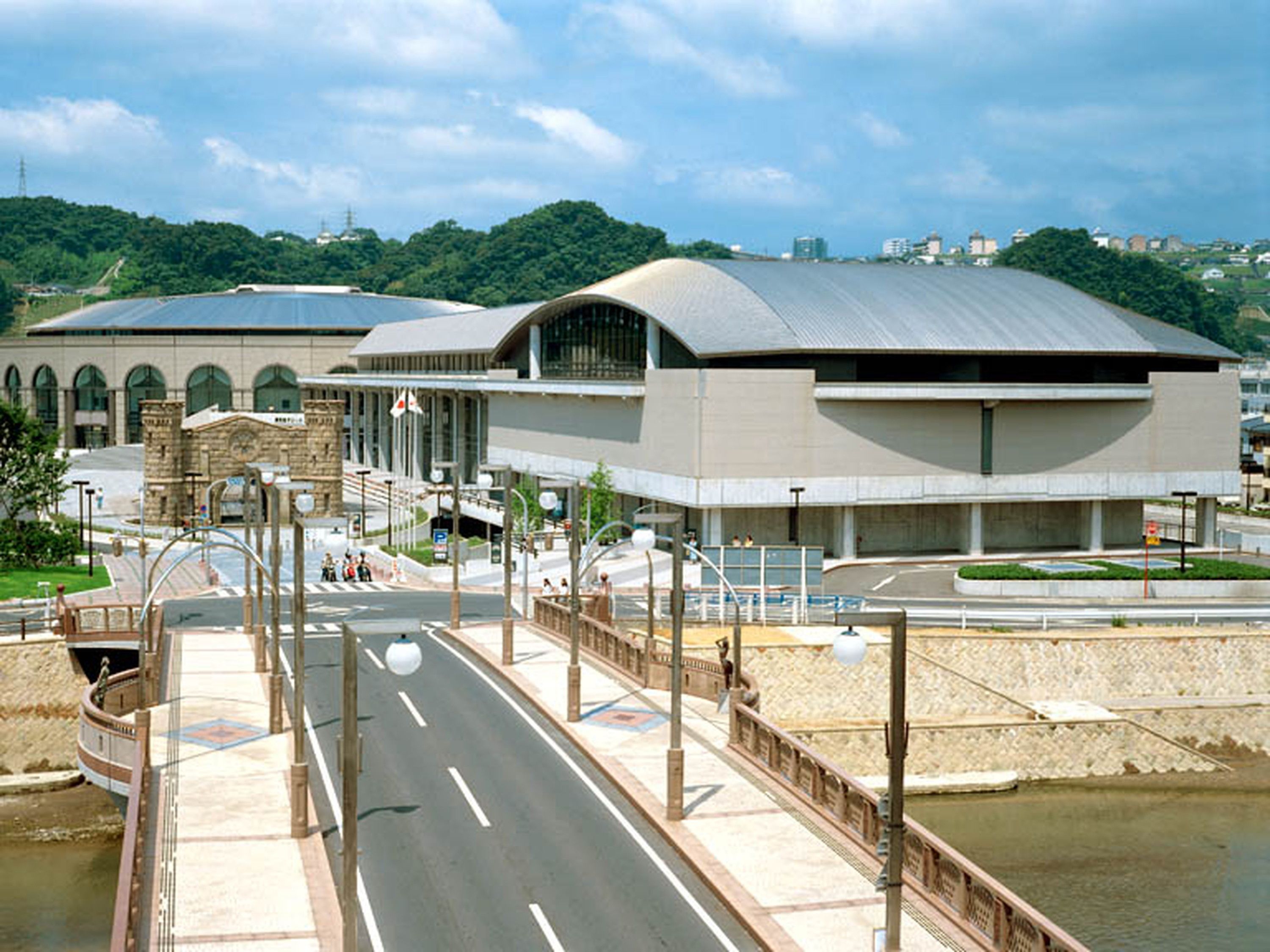 A modern building with a curved roof and a large entrance.