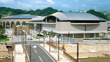 A modern building with a curved roof and a large entrance.