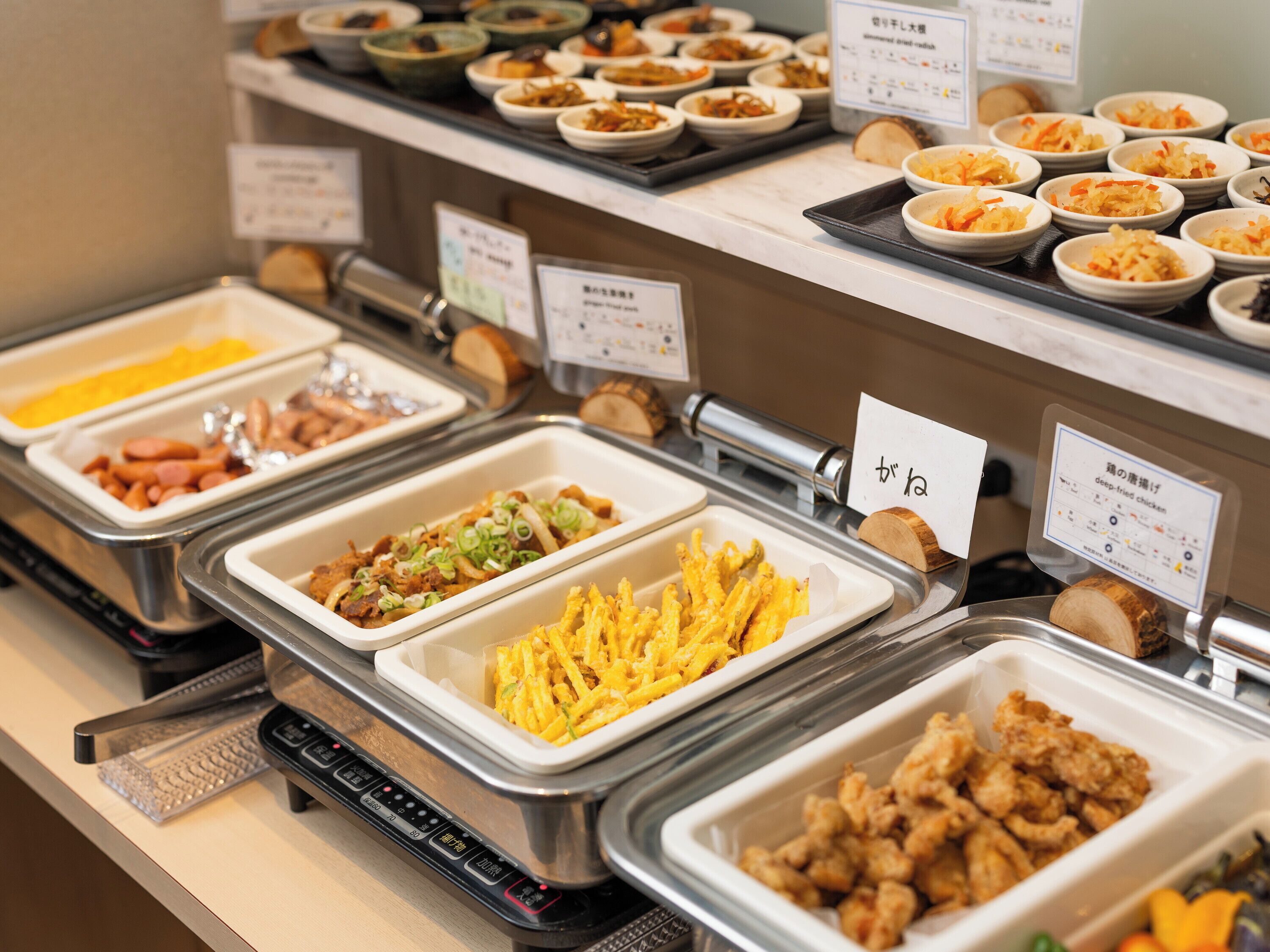 A buffet with various food options, including fried items and salads.