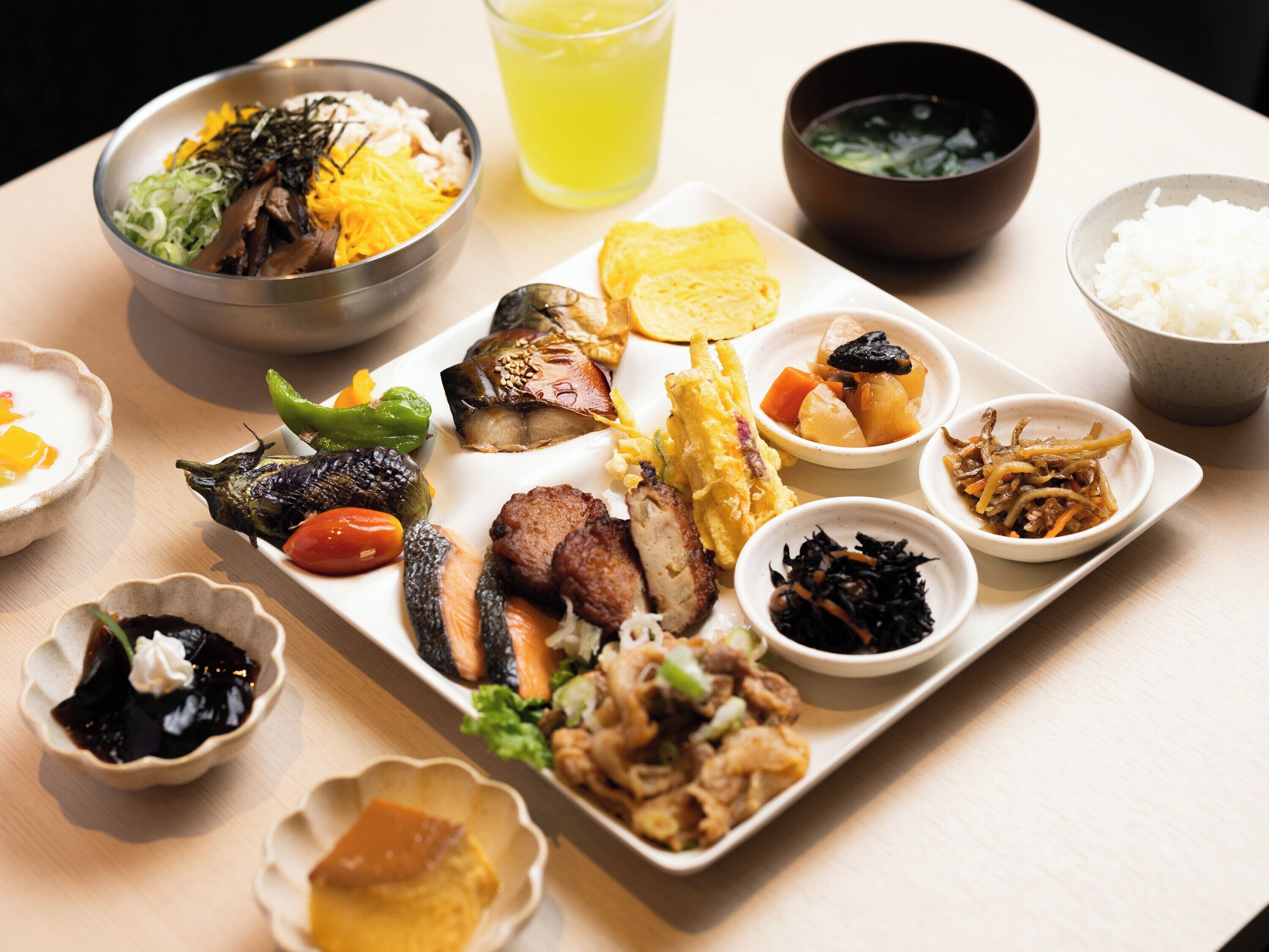 A variety of dishes on a table, including rice, vegetables, and meat.
