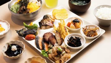 A variety of dishes on a table, including rice, vegetables, and meat.