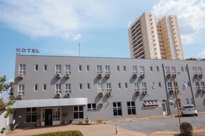 A hotel building with a flat facade, multiple windows, and a sign indicating it is a hotel. - Hotel Almanara (Cuiabá)