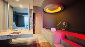 A modern bathroom with a bathtub, a vanity, and a shower area. - Ramada by Wyndham Mexico City Santa Fe (Mexico City)