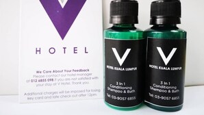 A V Hotel Kuala Lumpur sign with two bottles of shampoo and bath. - V Hotel (Kuala Lumpur)