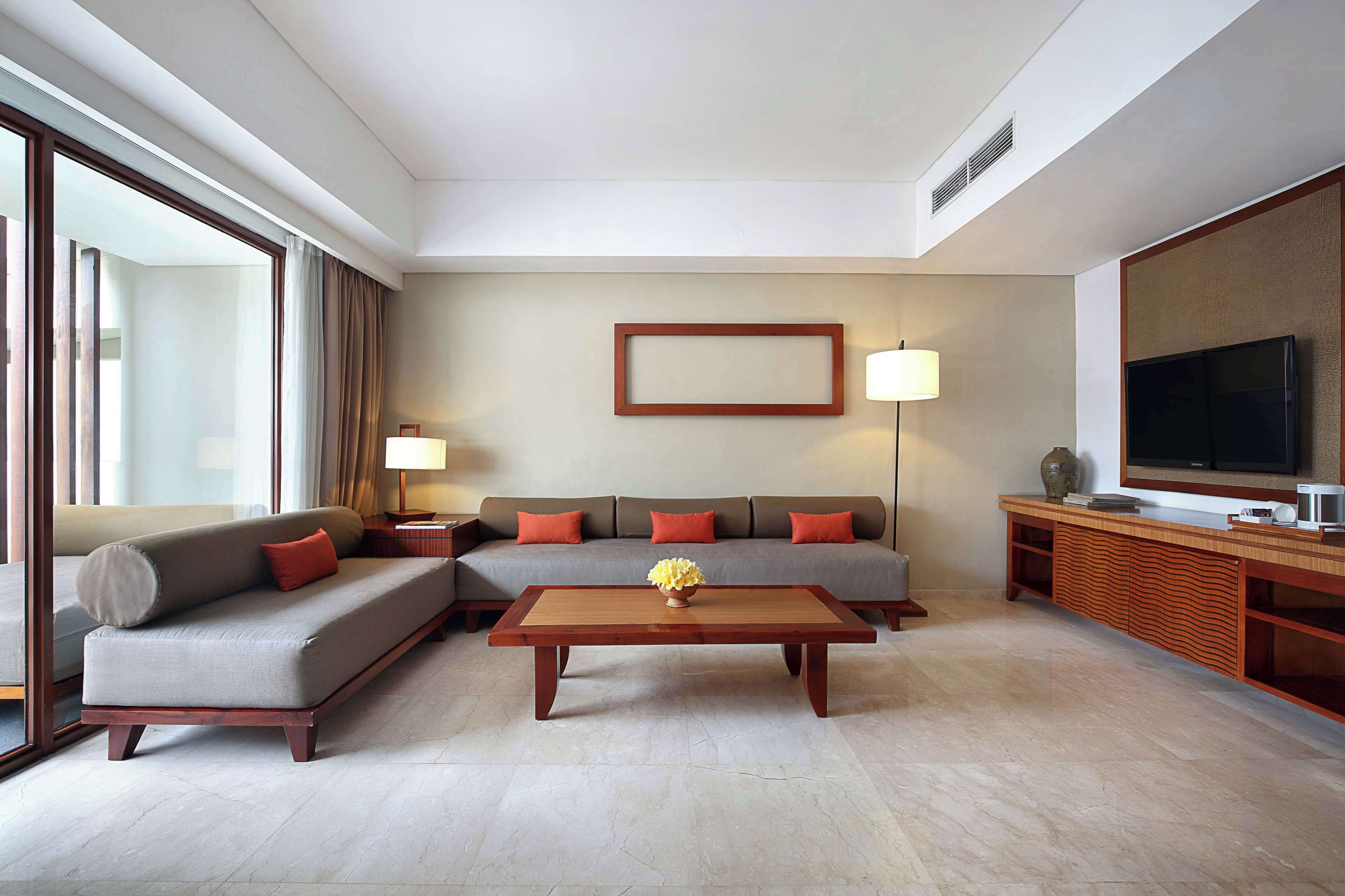 A modern living room with a sofa, coffee table, and TV.