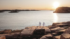 A coastal landscape with rocky terrain and a body of water.