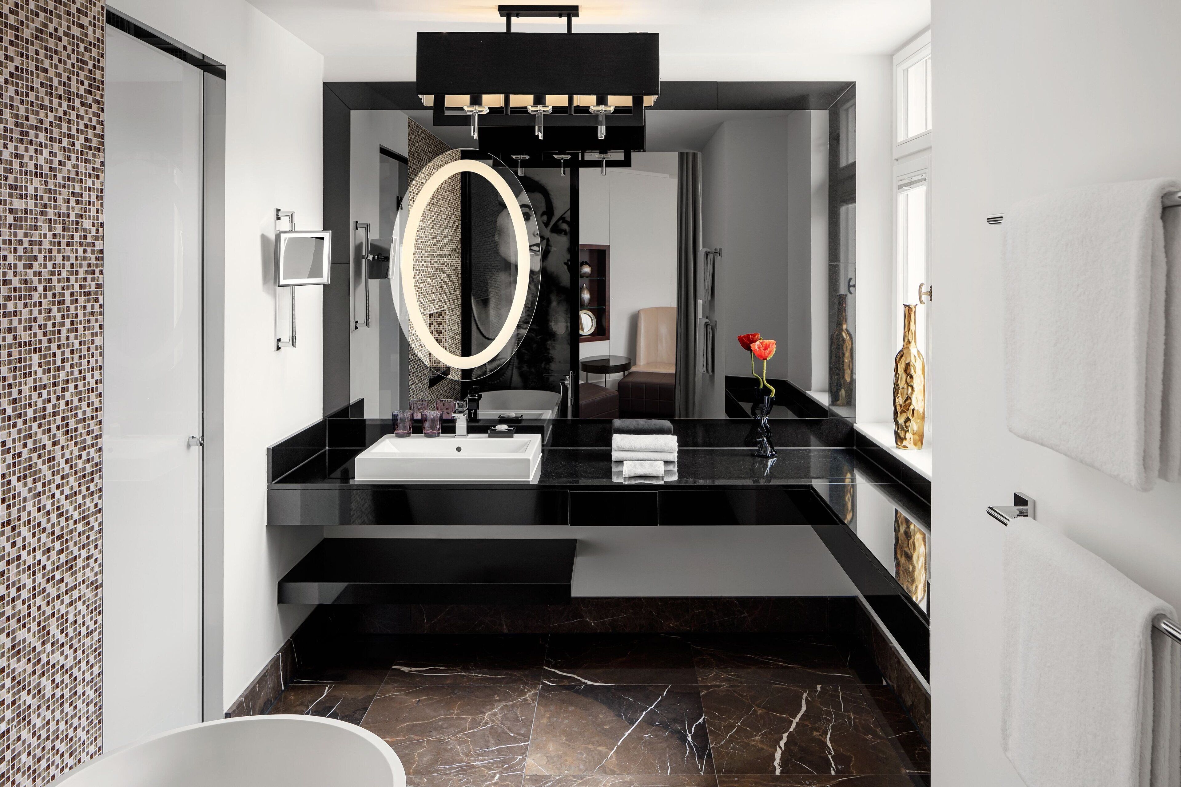 designer toiletries, hair dryer, slippers, towels