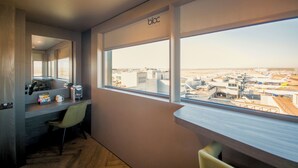 A hotel room with a large window offering a view of the airport and airplanes. - Bloc Hotel London Gatwick Airport (Gatwick)