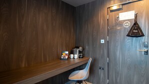 A modern bathroom with a wooden vanity, a coffee machine, and a towel hanging on a hook. - Bloc Hotel London Gatwick Airport (Gatwick)