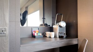 A modern kitchenette with a coffee machine, a mug holder, and a power outlet. - Bloc Hotel London Gatwick Airport (Gatwick)
