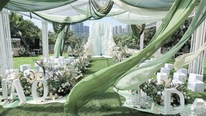 An outdoor wedding setup with white floral arrangements, a grassy area, and large white letters spelling "LOVE". - Crowne Plaza Chongqing New North Zone by IHG (Chongqing)