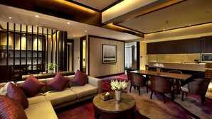 A modern living room with a sofa, coffee table, and dining area. - Crowne Plaza Chongqing New North Zone by IHG (Chongqing)