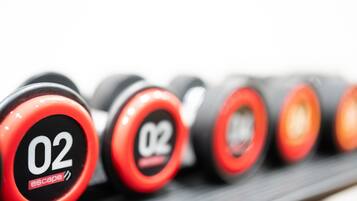 A row of red and black dumbbells with the number 02 and the word "escape" on them.