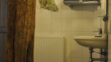 A bathroom with a toilet, sink, and towel rack.