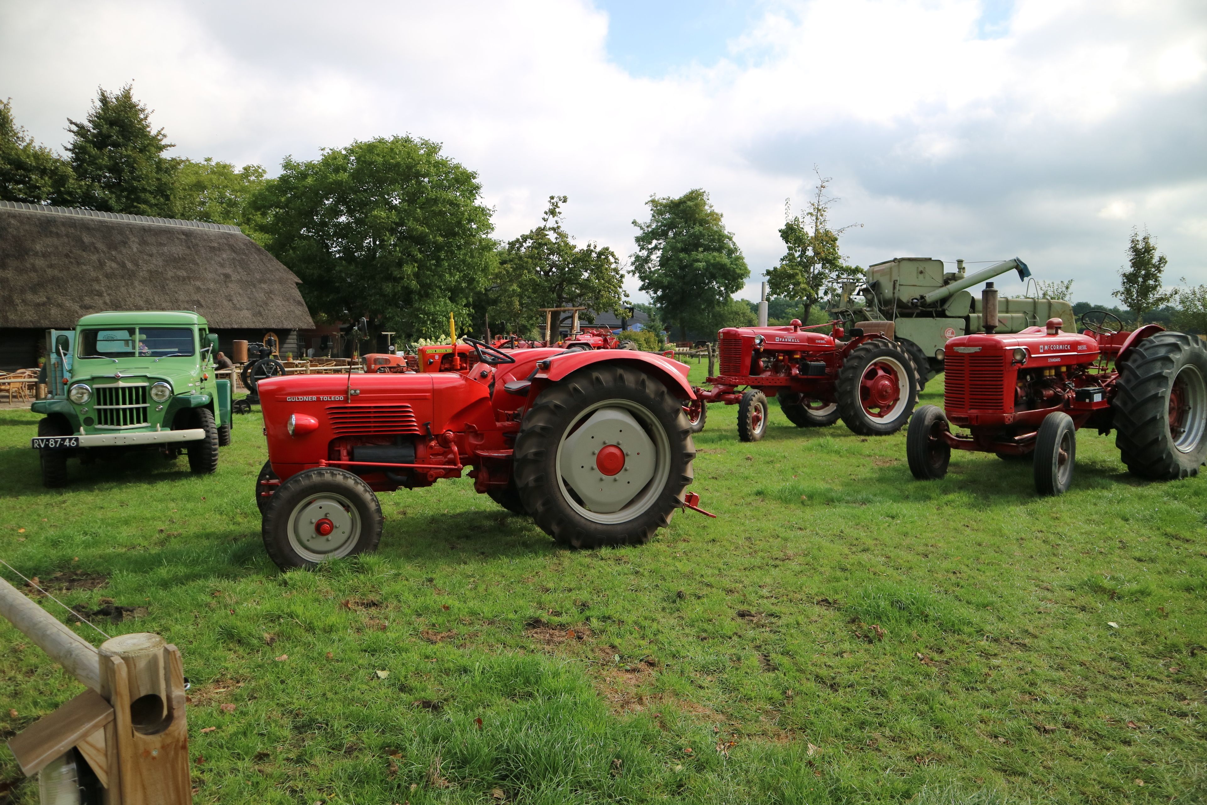 Vintage tractors parked on a grassy field.