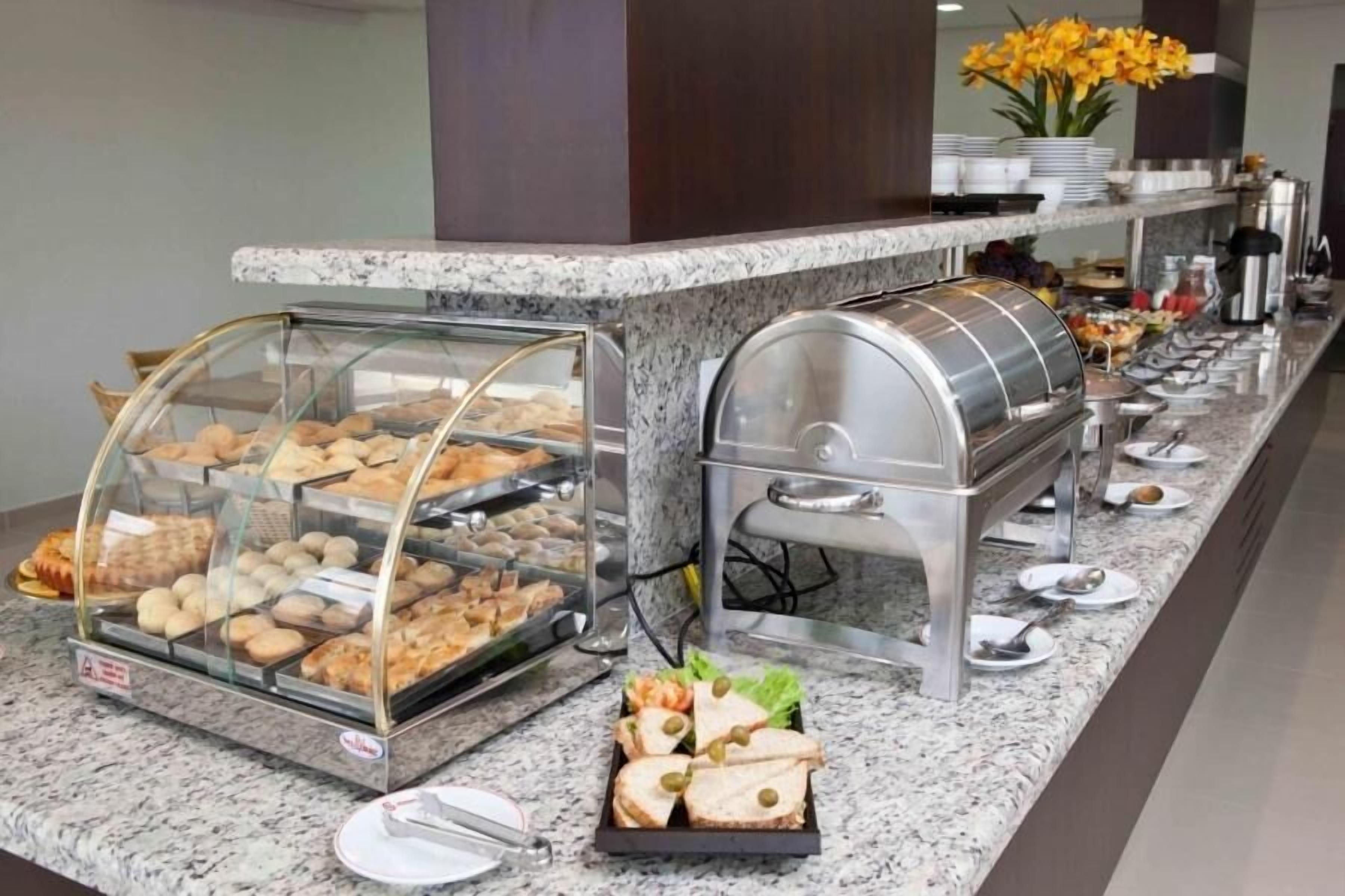 A buffet setup with various food items and a coffee station.