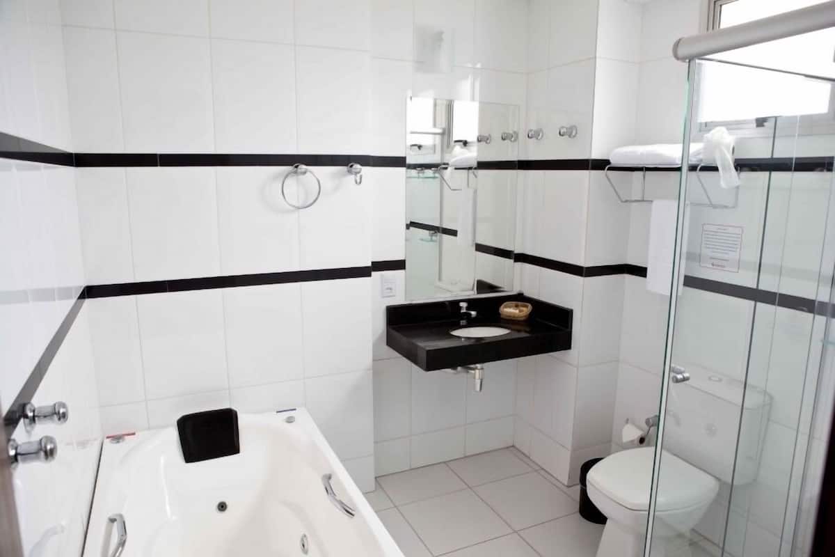 A modern bathroom with a bathtub, a sink, and a toilet.