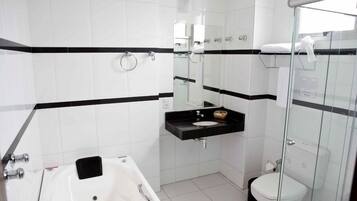 A modern bathroom with a bathtub, a sink, and a toilet.