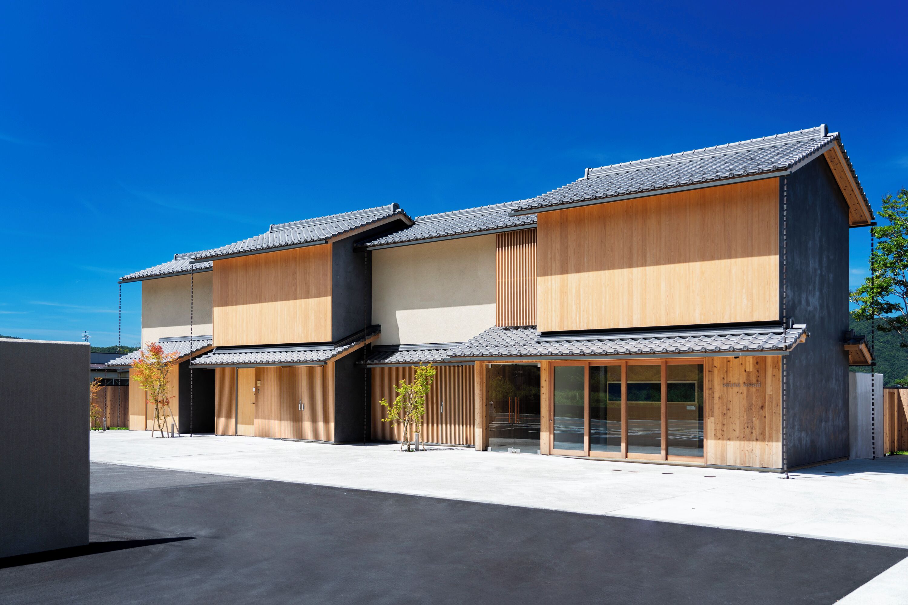 A modern building with a wooden facade and large glass windows.