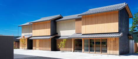 A modern building with a wooden facade and large glass windows.