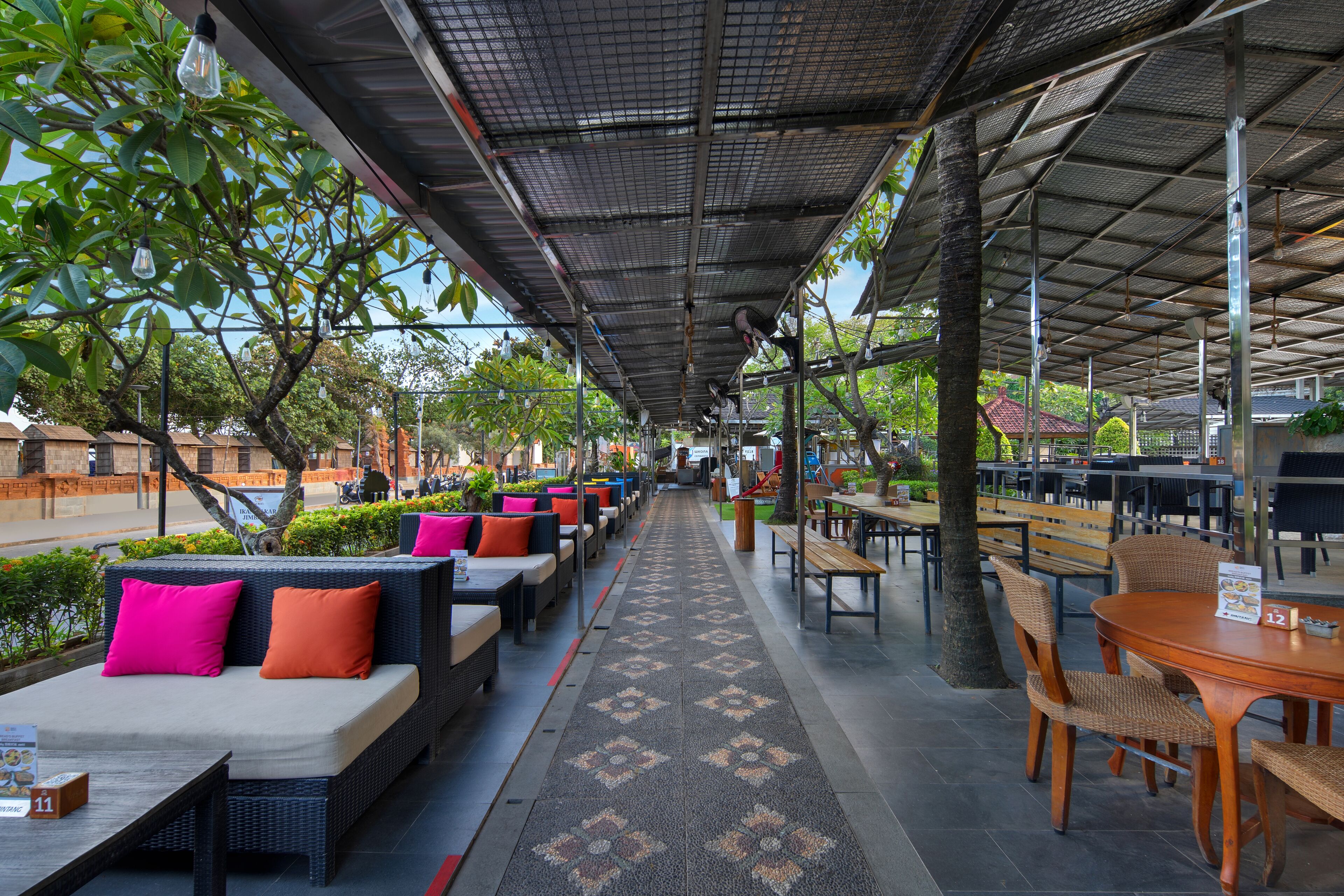 An outdoor seating area with wicker furniture and a patterned walkway.